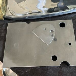 Michael Aram polished metal cheese board and knife.